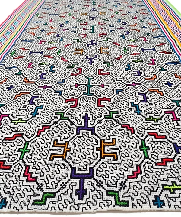 Detail of dense kené linework, the continuous line doubling back on itself across the whole cloth